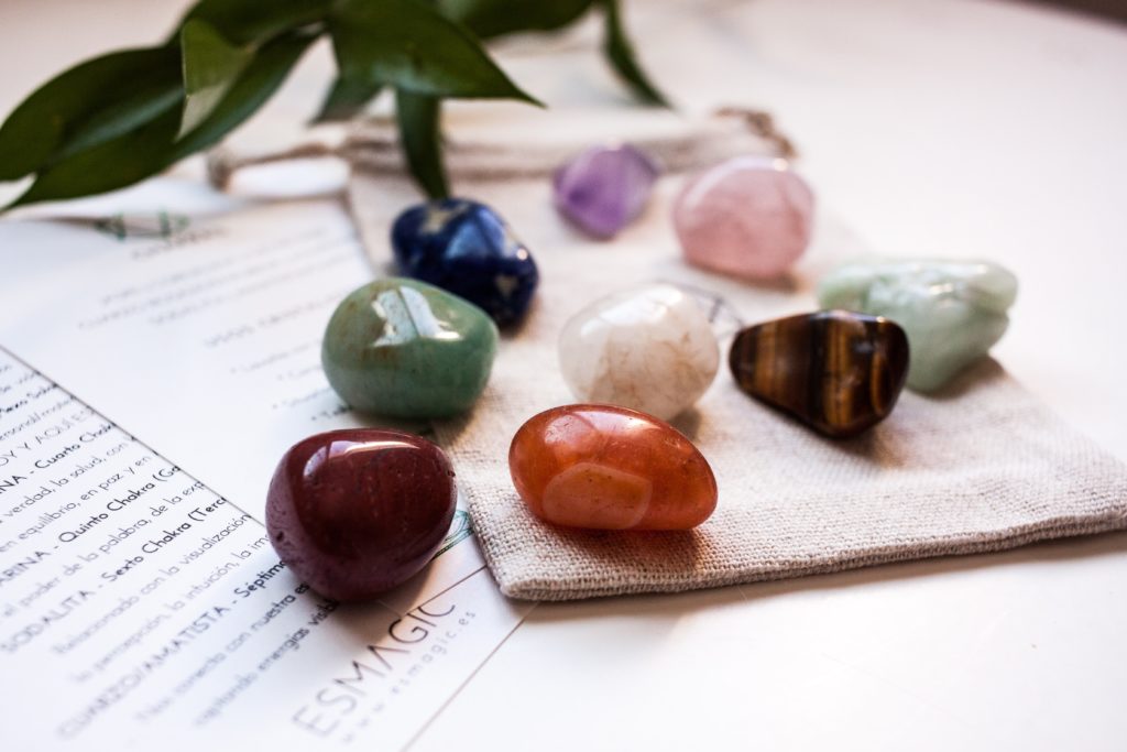 smooth stones on a table near a bag